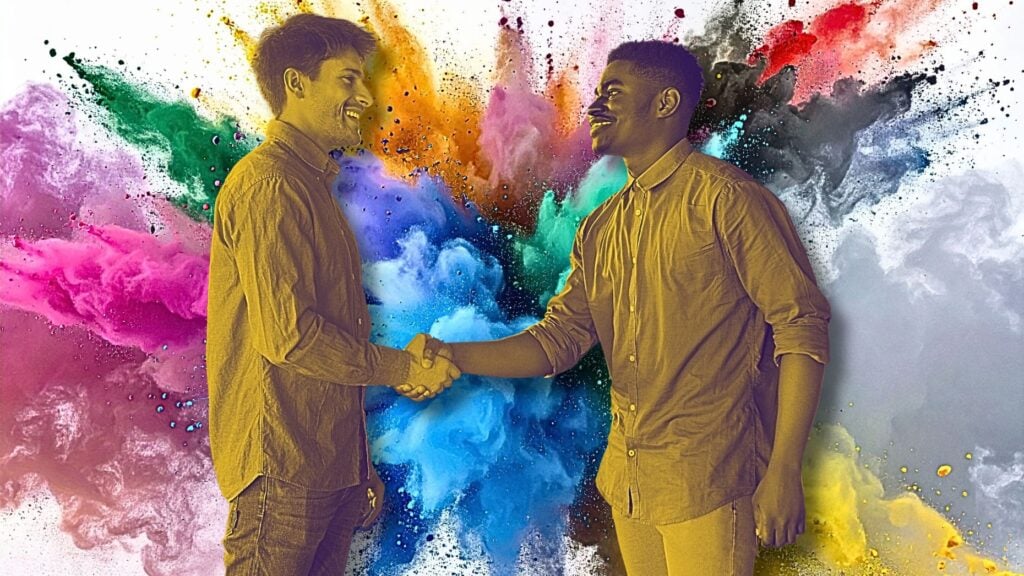 Two people shaking hands in front of an explosion of color to signify media outreach strategies for real estate.
