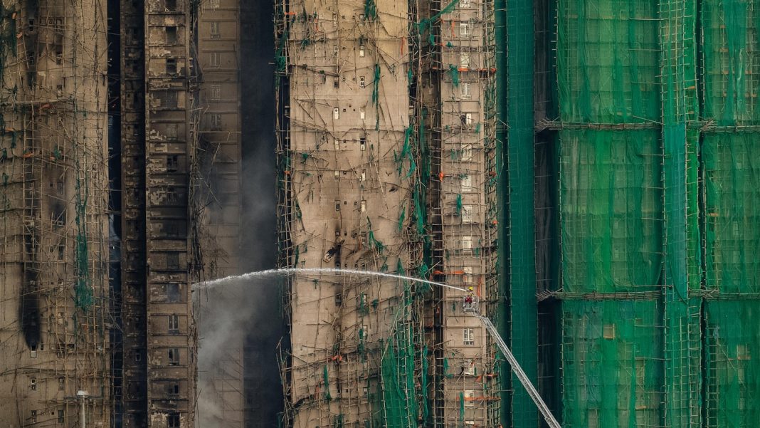At least 55 dead as Hong Kong firefighters battle burning towers for a second day